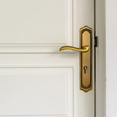 classic golden door handle on white door